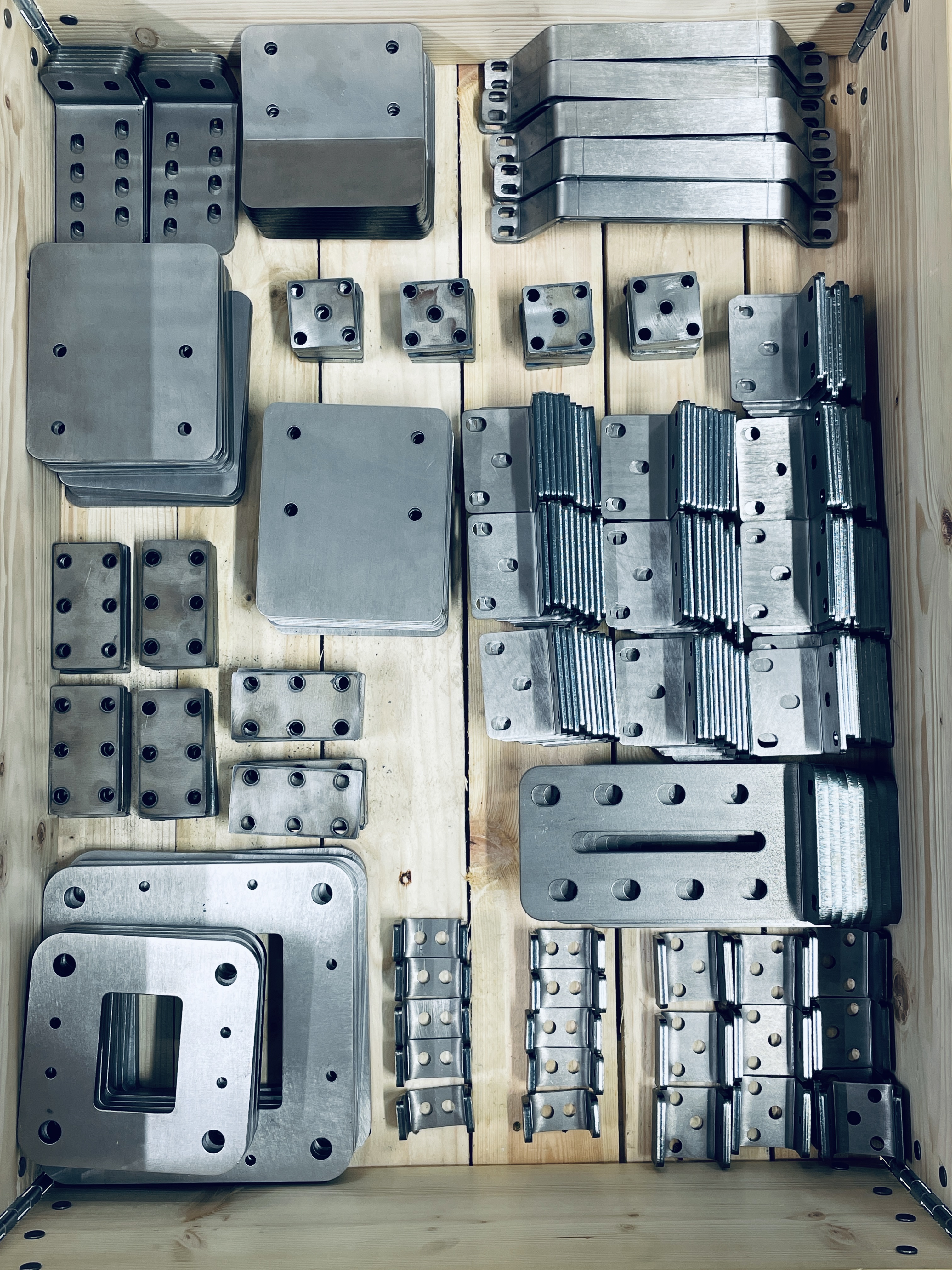 Laser-cut and bent machine parts ready for assembly.